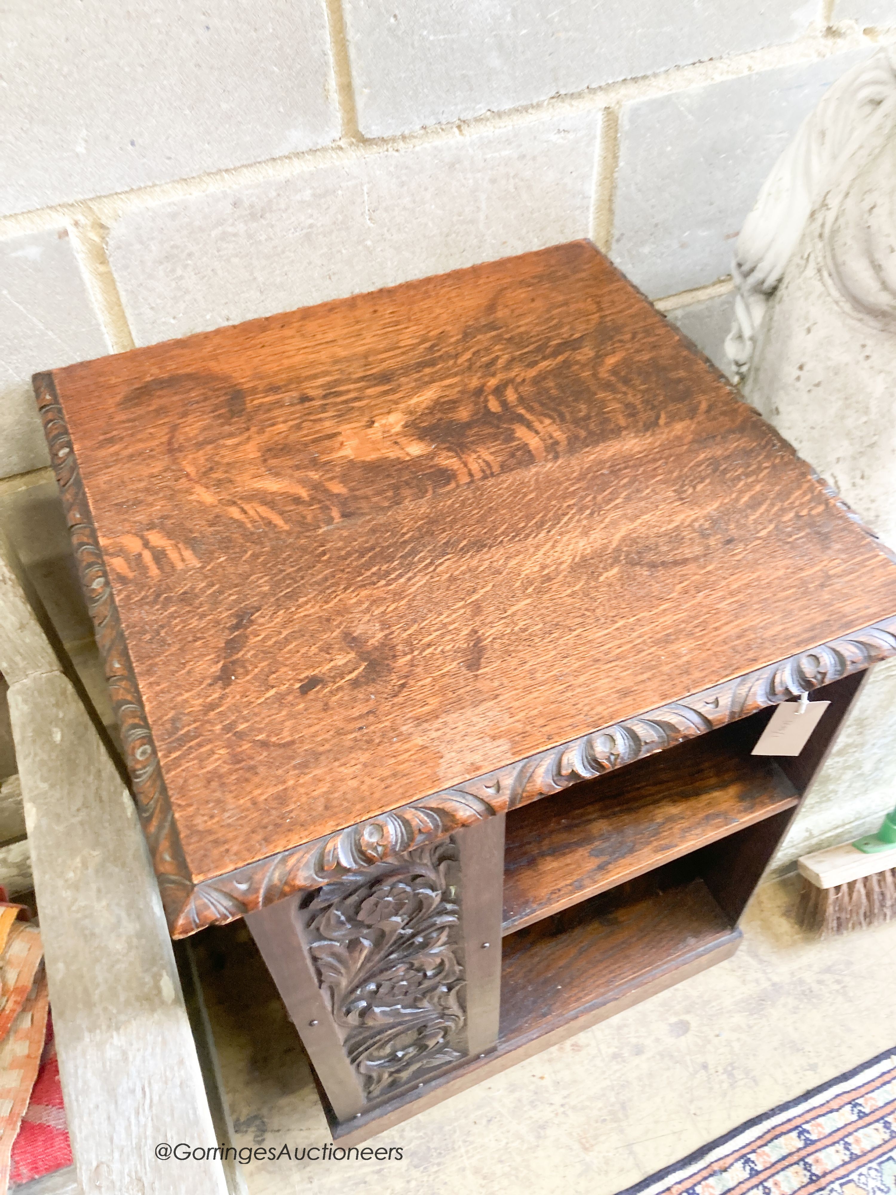 An early 20th century carved oak revolving bookcase, length 52cm, height 79cm